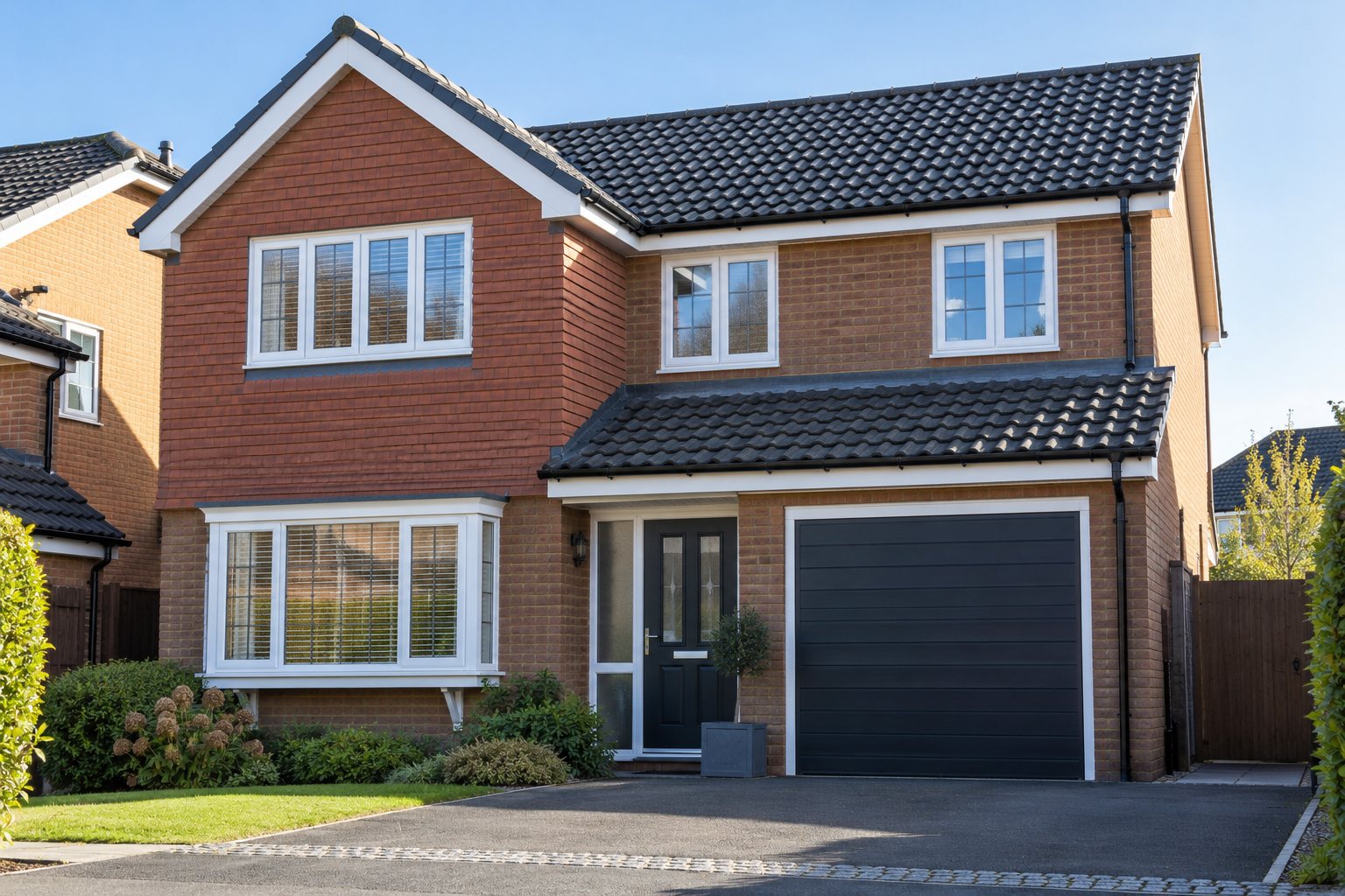 Detached red-brick house with new white fascias and soffits and black guttering